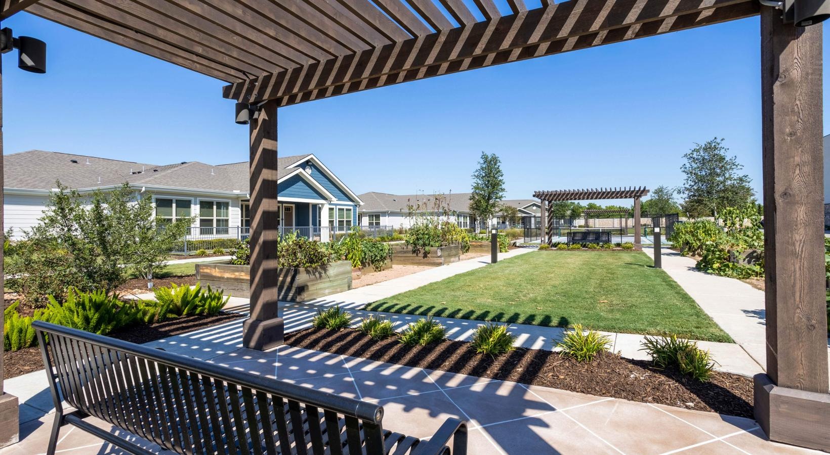 Settle into comfort at Larkspur at Shadow Creek a patio with a railing and a building in the background