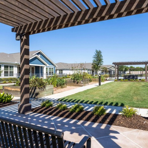 Settle into comfort at Larkspur at Shadow Creek a patio with a railing and a building in the background