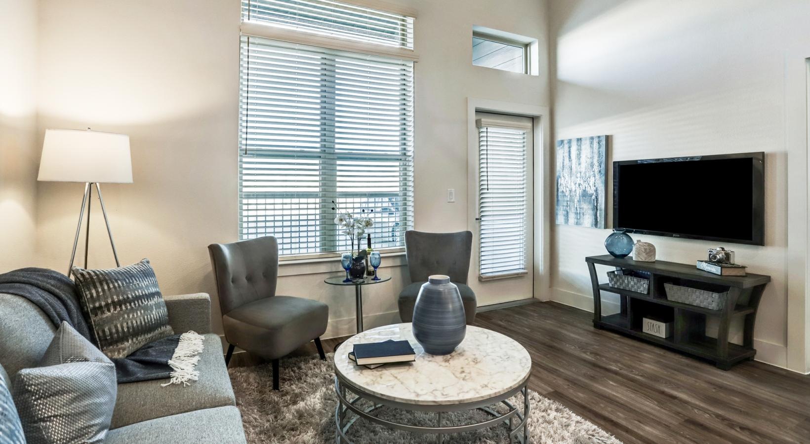 Wide open living areas flooded with natural light a living room with a tv and couches