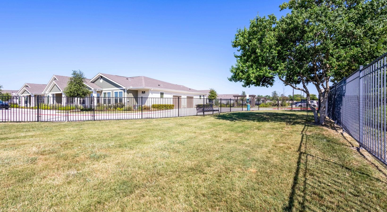 A perfect fit for the whole family a fenced in yard with a white picket fence and a tree