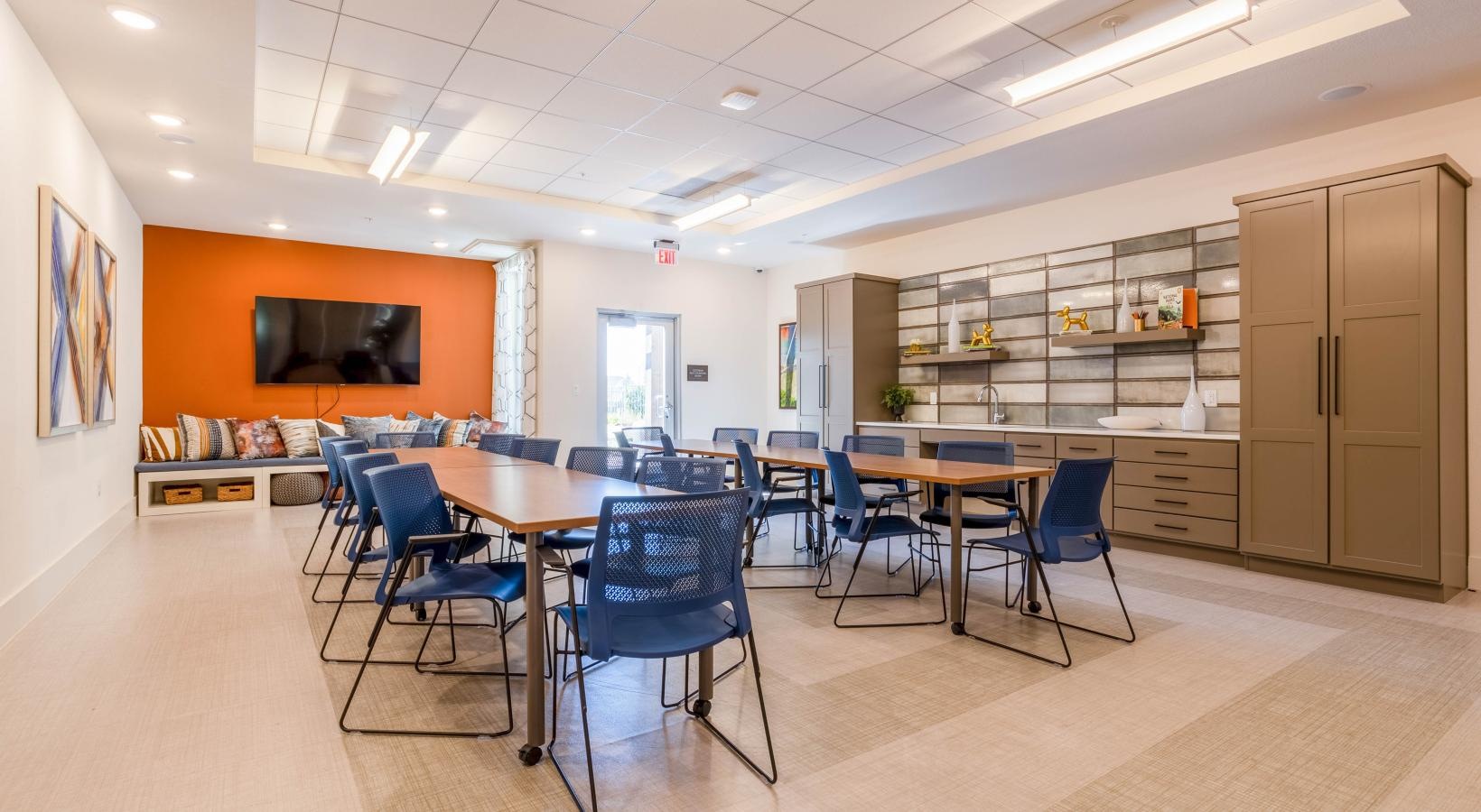 Access to resident-only features a room with tables and chairs