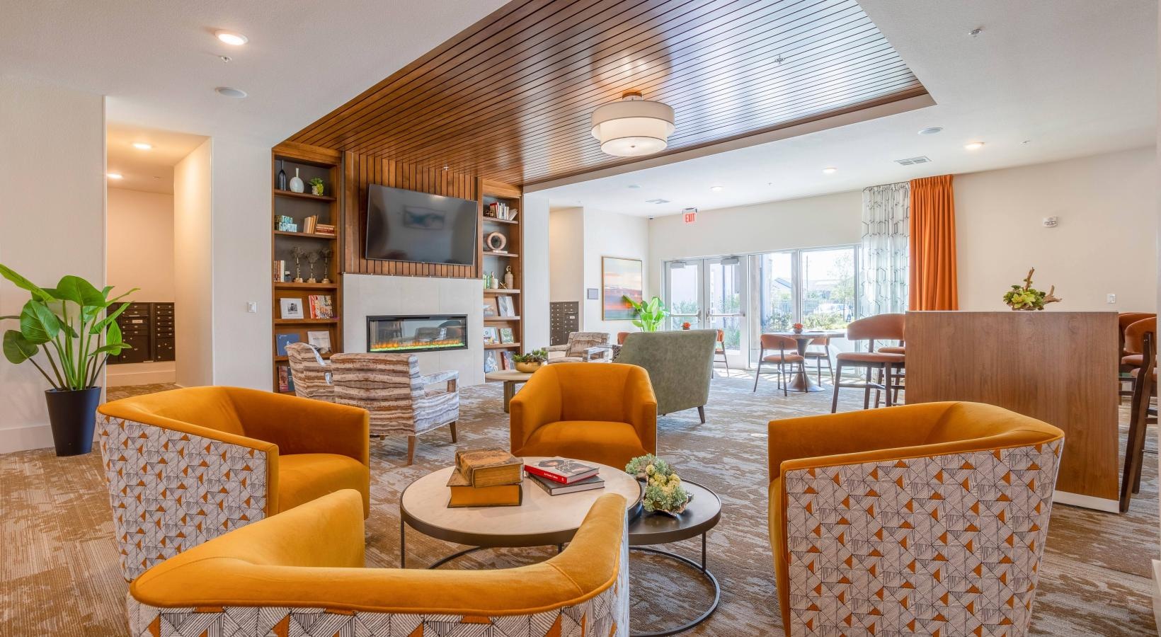 Find your perfect fit at Larkspur at Shadow Creek a room with yellow couches and a table with chairs