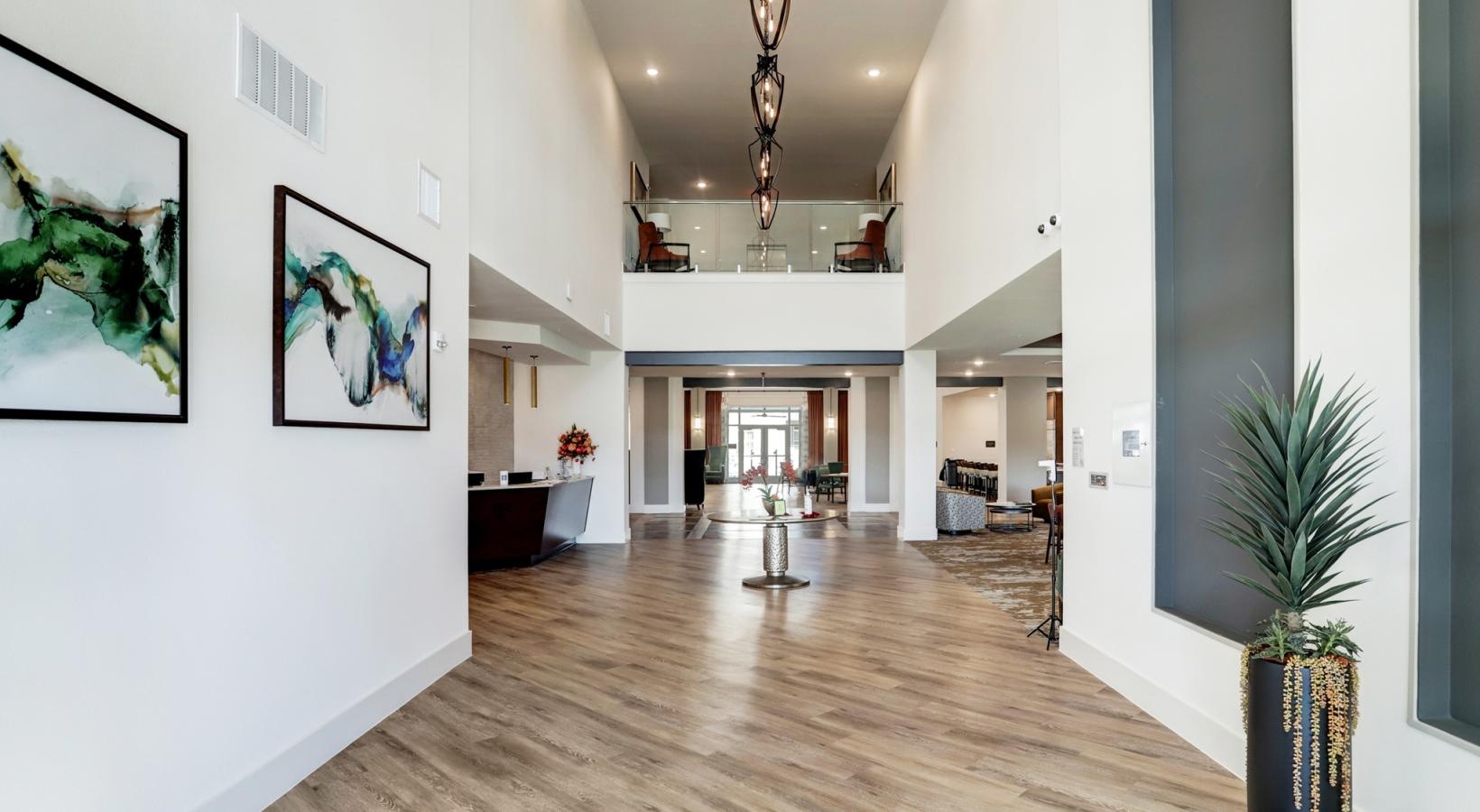 Access to resident-only features a long hallway with a chandelier and a vase of flowers